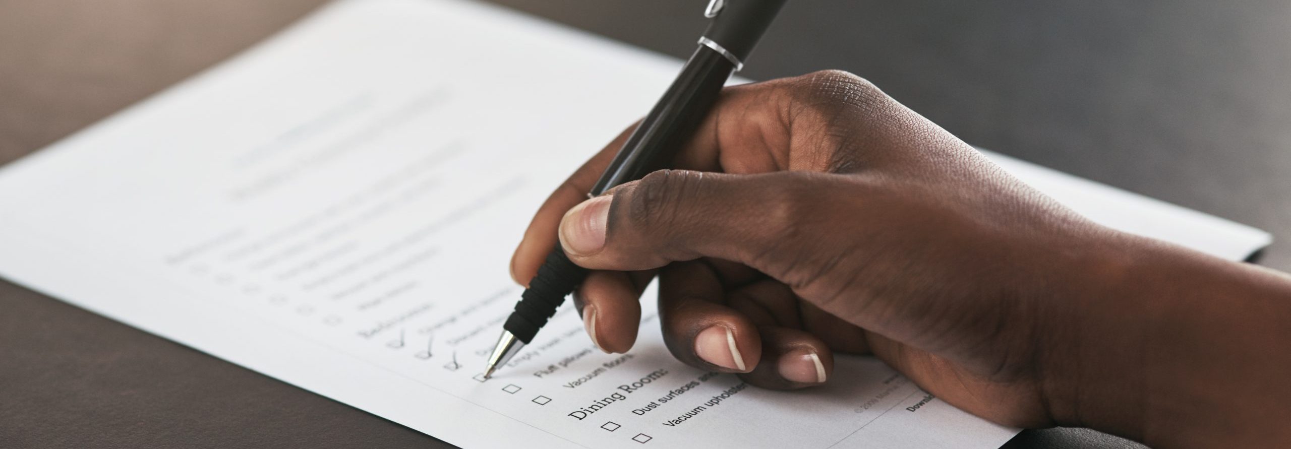 Checklist tick, closeup and hands with a pen, agenda or planning administration at work. Receptionist, plan and person with notes on a document for schedule, time management or working on a goal
